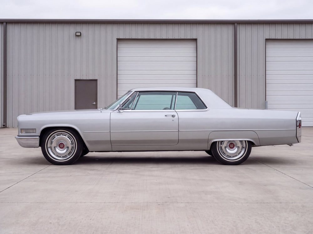 1966 Coupe de Ville, outside the shop with 66 Cadillac wheels