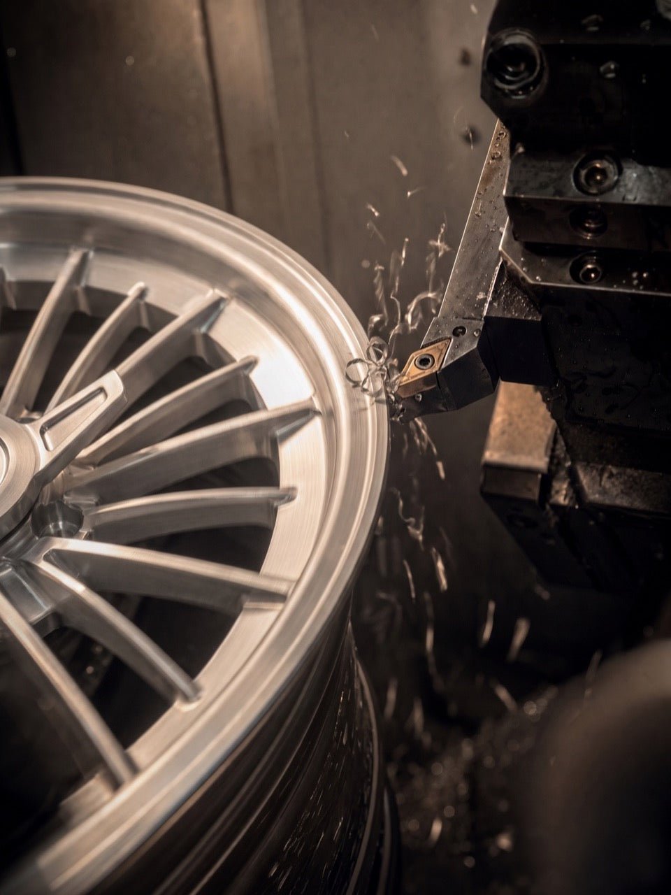 A Stripper 17-inch wheel being machined on a CNC lathe, aluminum chips curling off the cut